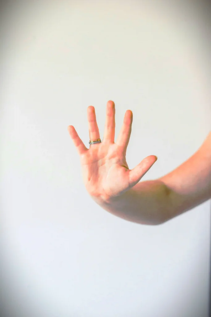 A Hand of an Epoxy Floor Installer Showing 5 Benefits of Epoxy Floors